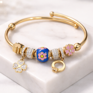 Elegant Gold-Tone Charm Bangle Bracelet with Floral & Crystal Accents